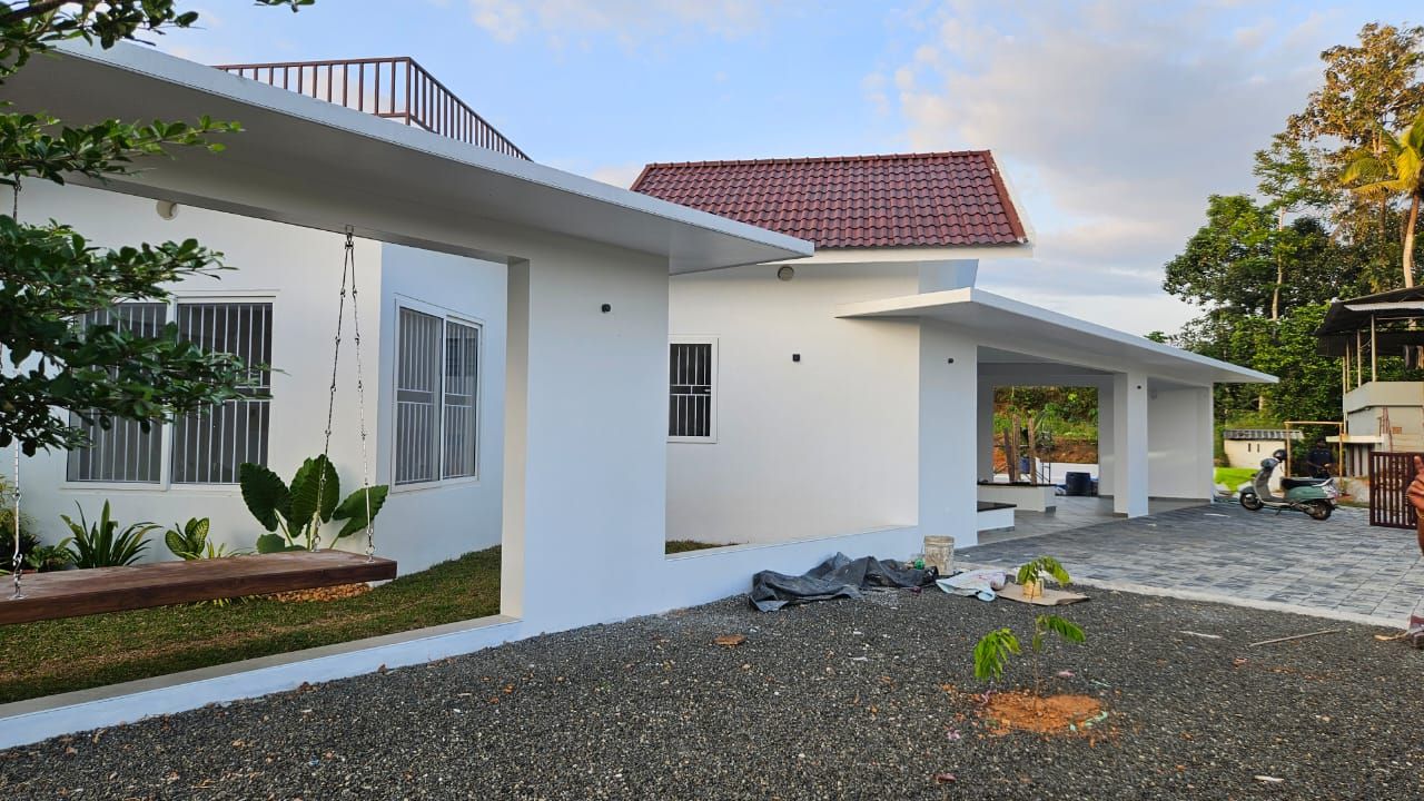 Side elevation of the modern white home, highlighting the open-air courtyard view and car porch structure.