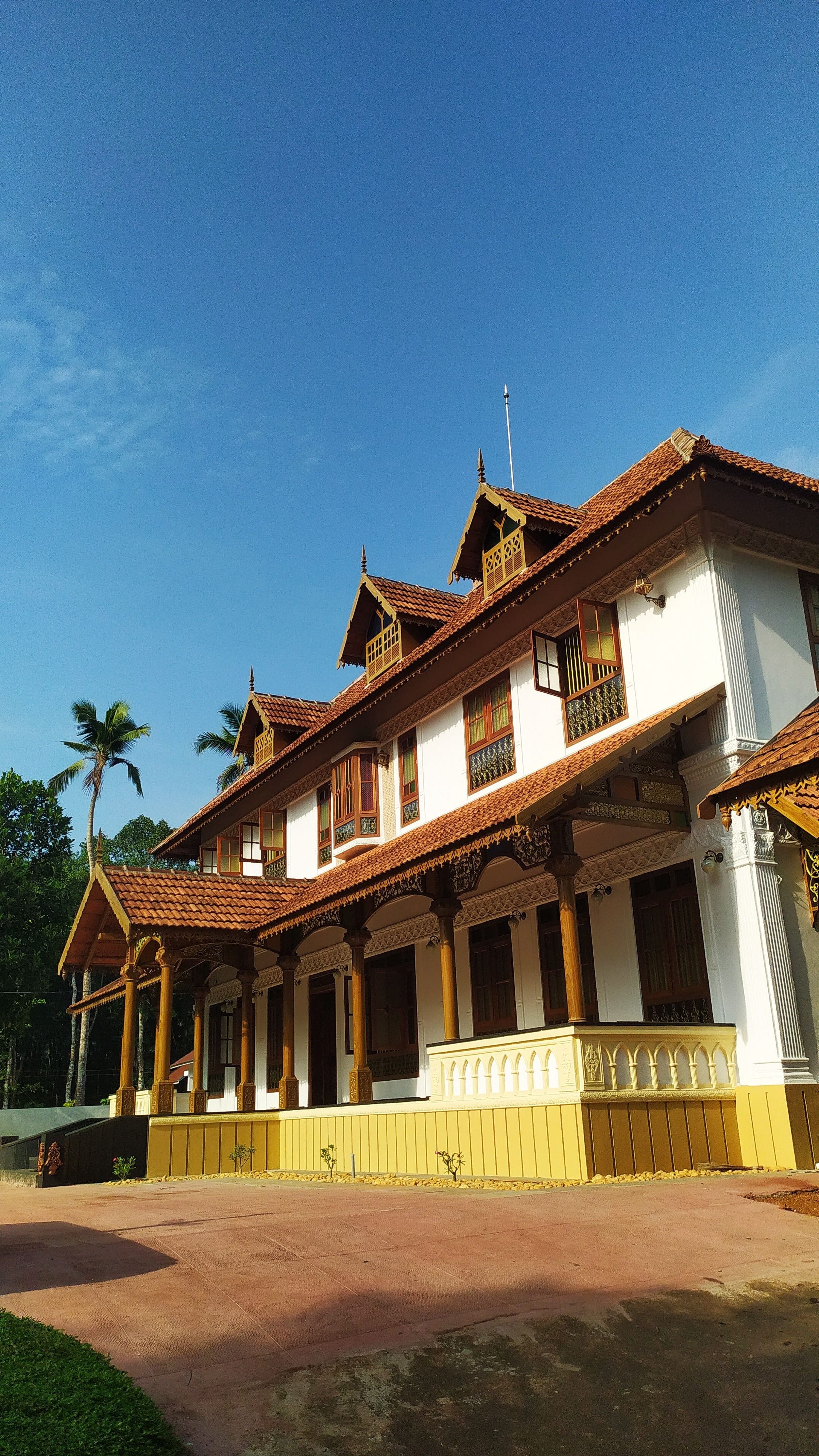 Low-angle side view highlighting the traditional wooden eaves, pillars, and grand facade.